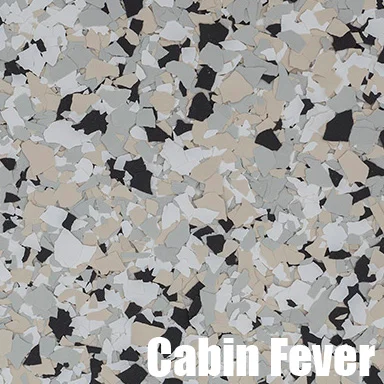 Multi-colored epoxy flake flooring with black, white, tan, and gray decorative chips in clear epoxy base